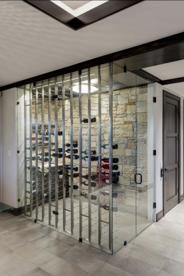 glass wine room, metal racks, stone wall
